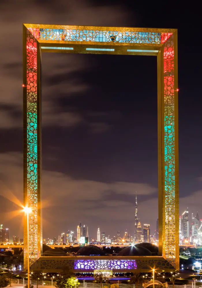 The Dubai Frame lit up at night, the perfect place to visit in Dubai's winter months.