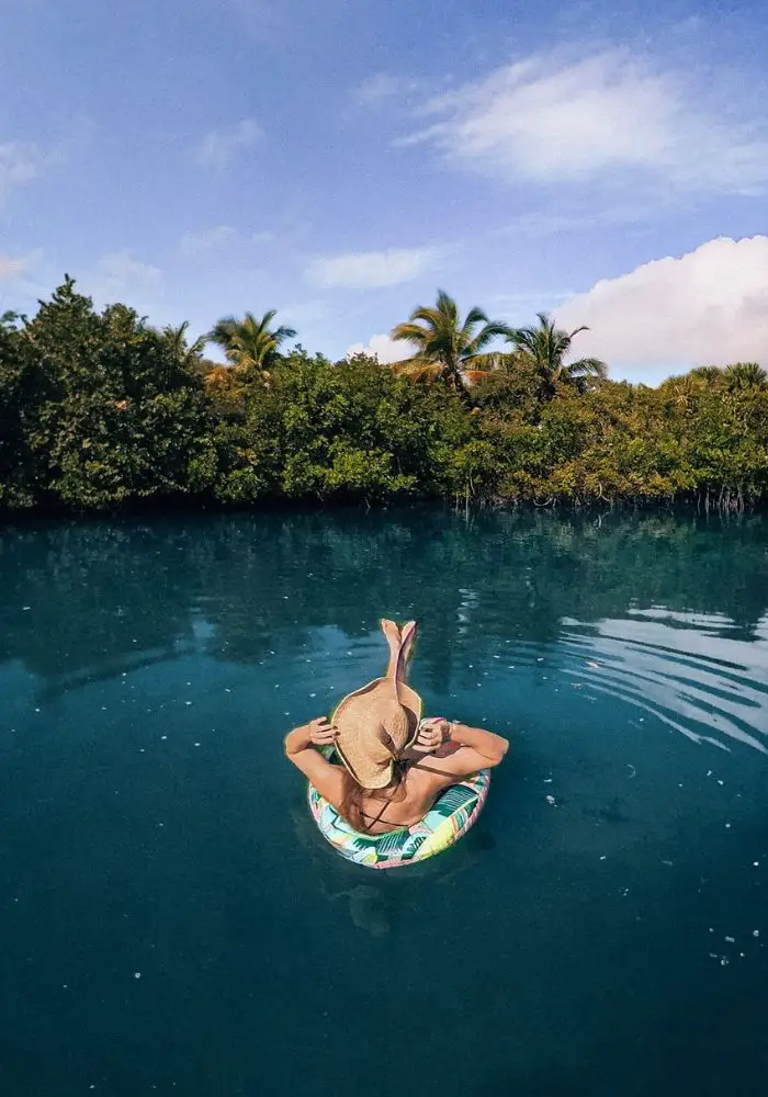 Monica floating on a tube at Peanut Island, one of the best islands close to Florida.
