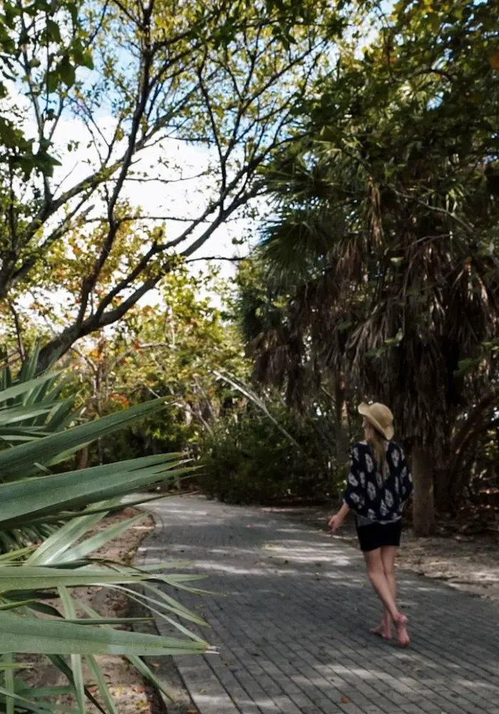 Monica walking the shaded path around Peanut Island, one of the best islands close to Florida.