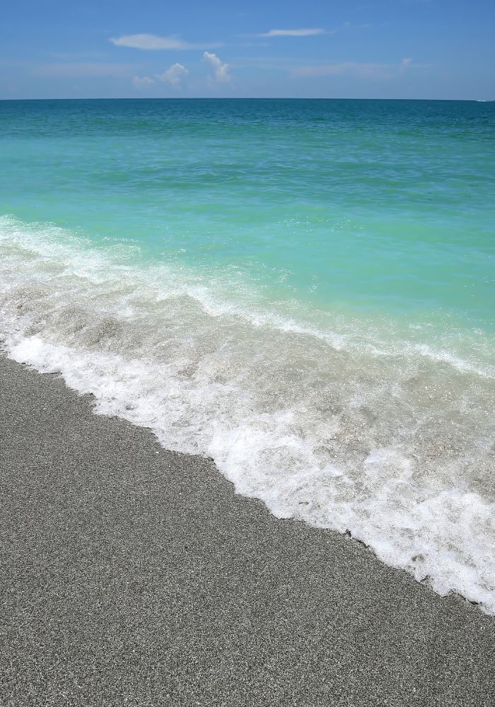 The dark sand and clear blue water at Sanibel and Captiva Island, one of the best islands close to Florida.