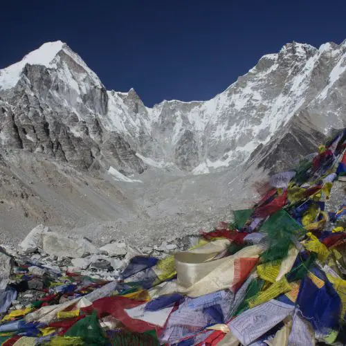 Mount Everest with colorful NEpal flags in the wind.