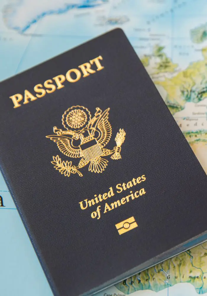 A United States passport on top of a map.