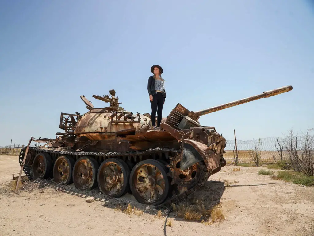 Monica on the top of a rusty, abandoned Iraqi tank on Failaka Island Kuwait.