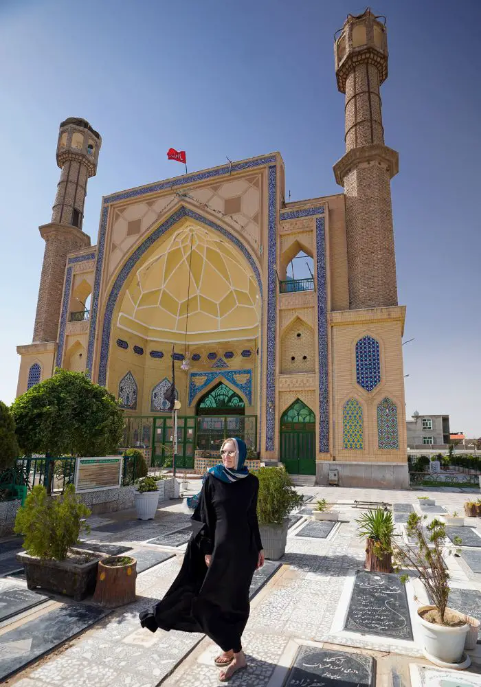 Monica, a woman traveling Afghanistan, exploring colorful mosques in summer.