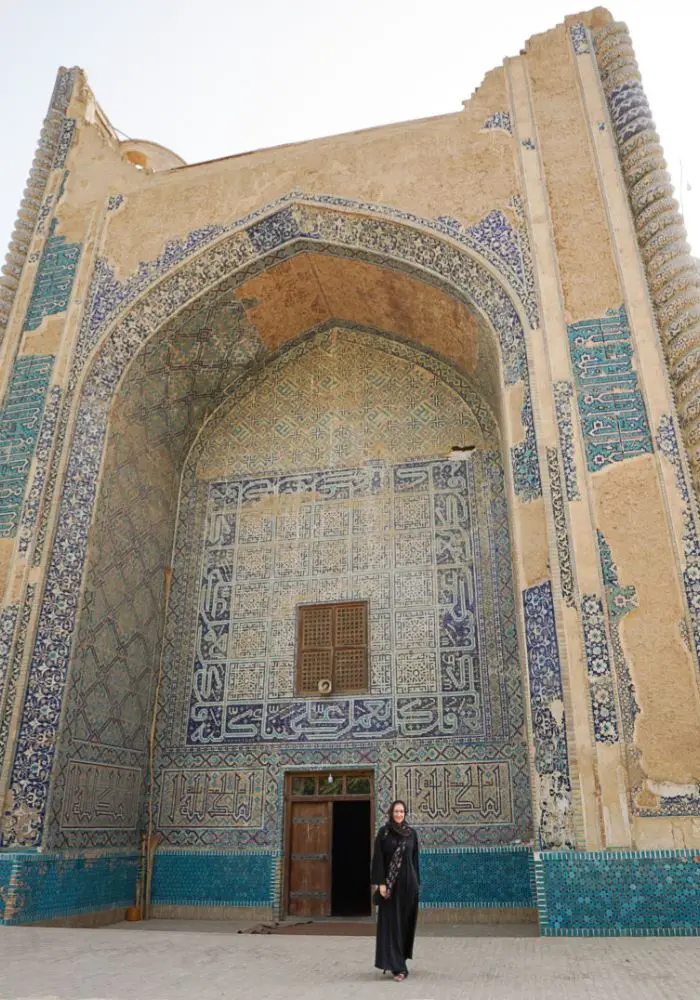 Monica traveling in Afghanistan and walking near the Mosque of Khawaja Abu Nasr Parsa.