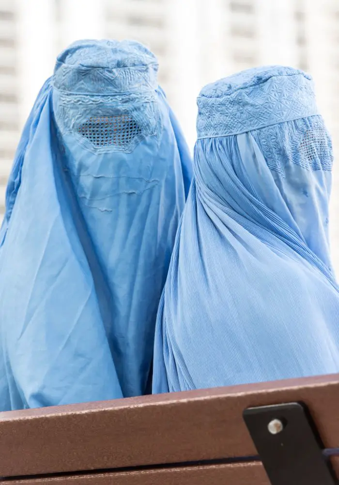 Two women in Afghanistan wearing the traditional blue burqa.