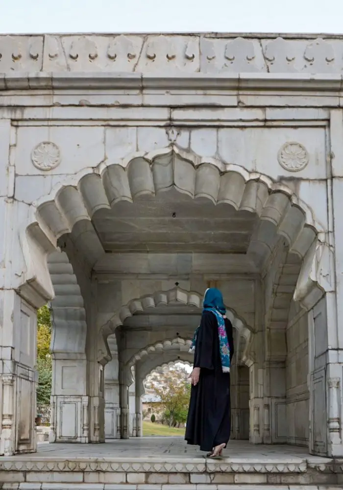 A girl walking through Babur Gardens in Kabul Afghanistan as a tourist.