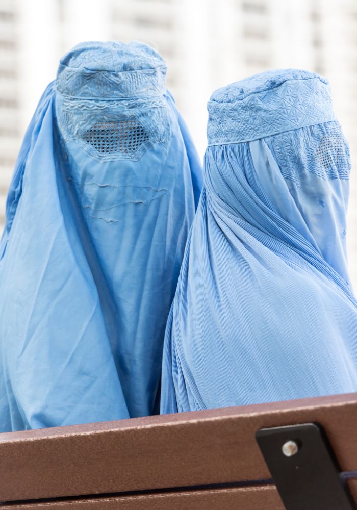 Afghan women wearing light blue burqas.